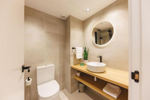 a bathroom with a white toilet and a sink at Bravissimo Devesa, 3 bedrooms and near the parc in Girona