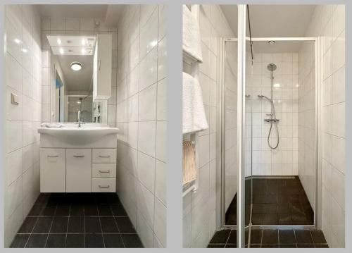 a white bathroom with a sink and a shower at Borneman Buitenhof - Privé Appartement in Houten