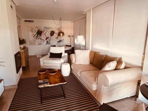 a living room with a couch and a table at Apartamento de lujo cerca de La Isla del Fraile in Águilas