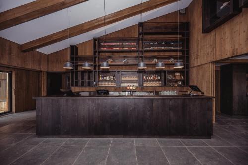 a bar in a room with wooden walls at Highland Base Kerlingarfjöll in Kerlingarfjoll