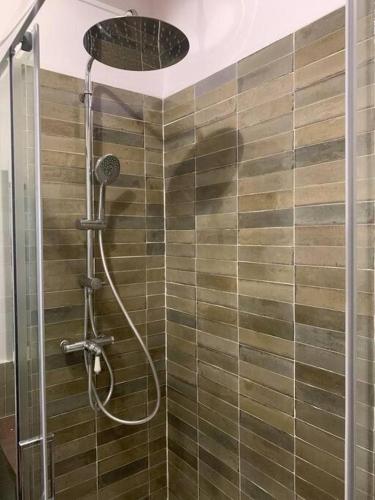 une salle de bain avec une douche avec une porte vitrée dans l'établissement Magnifique maison en pierre avec piscine, à Soyans