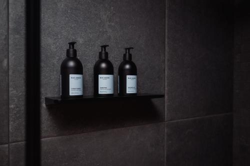 three bottles of wine sitting on a shelf on a wall at Highland Base Kerlingarfjöll in Kerlingarfjoll