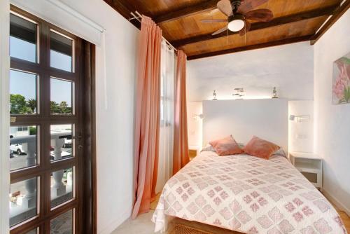 a bedroom with a bed and a ceiling fan at El Drago in Costa Del Silencio