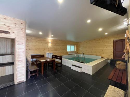 a room with a bathtub and a table and a table at Barvy Dnipra in Dnipro