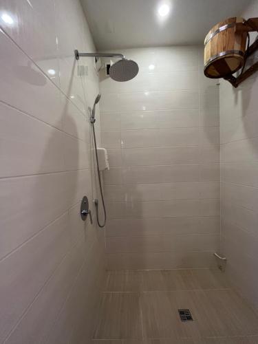 a shower with a shower head in a bathroom at Barvy Dnipra in Dnipro