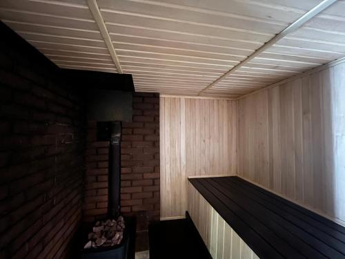 a sauna with a brick wall and a heater at Barvy Dnipra in Dnipro