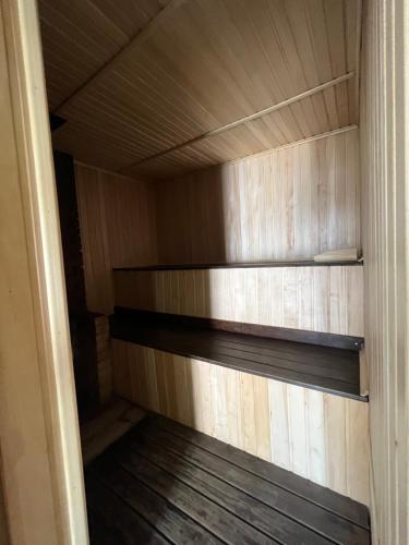 a closet with wooden shelves in a room at Barvy Dnipra in Dnipro