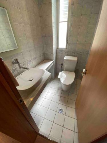 a bathroom with a toilet and a sink at 貸切別荘カリイ Vacation Rental KALLY Naha Okinawa in Naha