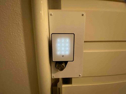 an alarm clock on a wall in a room at 貸切別荘カリイ Vacation Rental KALLY Naha Okinawa in Naha