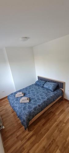 a bedroom with a bed with two pillows on it at Amar 4 in Zemun