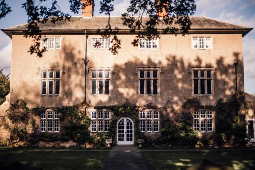 an old house with a tree in front of it at Woodborough Hall in Woodborough