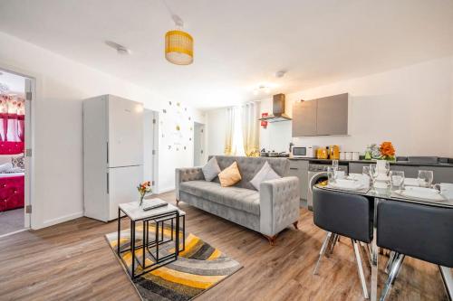 a kitchen and a living room with a couch and a table at *F2BR* for your most relaxed & Cosy stay + Free Parking & WiFi in Batley