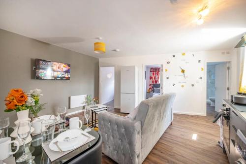 a living room with a couch and a table at *F2BR* for your most relaxed & Cosy stay + Free Parking & WiFi in Batley
