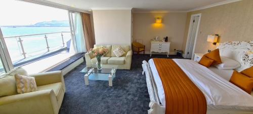 a hotel room with a bed and a large window at The Empress Hotel in Douglas