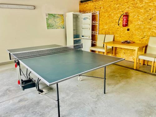 a ping pong table in a room with chairs at Dům nad Pržnem in Jablŭnka