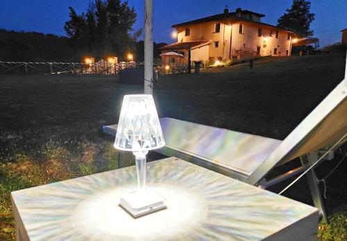 a lamp on a table in a yard at night at La valle B&B in Cavriglia