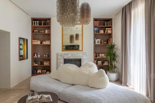 a bedroom with a large white bed and a fireplace at Luxe Rome apartment in Rome