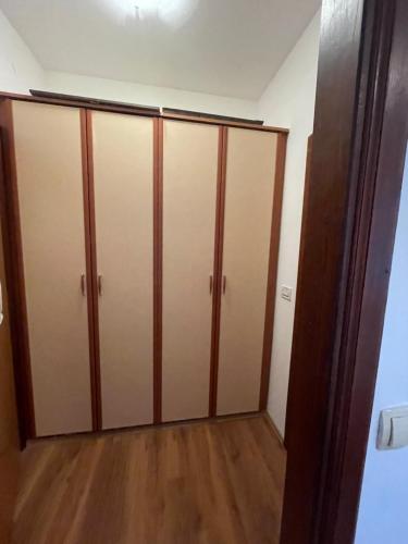 a closet with wooden doors in a room at Vila Liza in Trogir