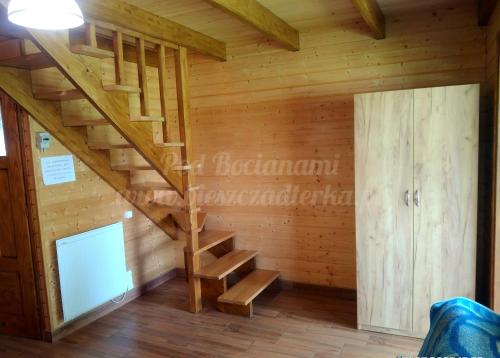 drewniana klatka schodowa w pokoju z drewnianymi ścianami w obiekcie Agroturystyka Pod Bocianami Terka w Polańczyku