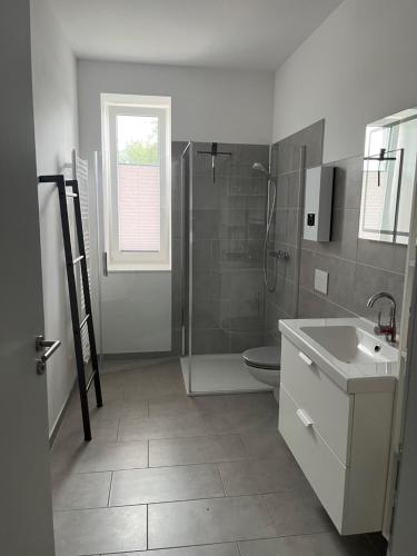un bagno con doccia, lavandino e WC di Ferienwohnung Kolow GbR ad Angermünde