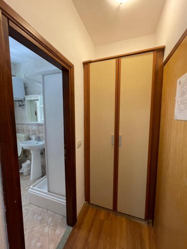 a bathroom with a glass door leading into a bathroom at Vila Liza in Trogir