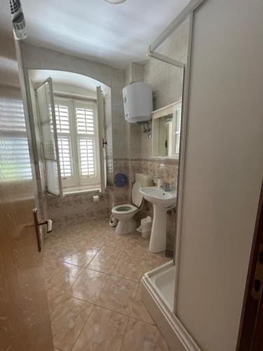 a bathroom with a toilet and a sink at Vila Liza in Trogir