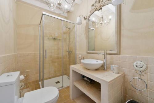 a bathroom with a sink and a toilet and a shower at Dalt Vila House in Ibiza Town