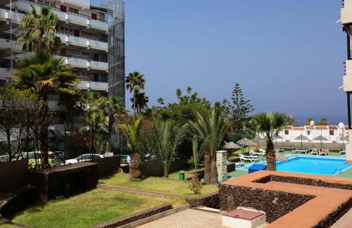 a view of a swimming pool and a building at TENERIFE Olympia Apart Hotel-Playa de las Americas. Balcony, sea view & pool in Playa de las Americas