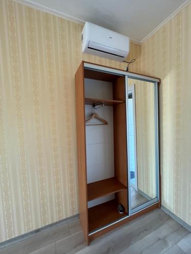 a room with a closet with a tv and a mirror at Barvy Dnipra in Dnipro