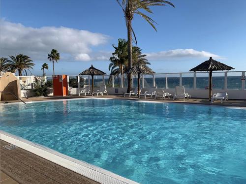 a large swimming pool on top of a building at Bungalow Uno - Front Line of Ocean in San Bartolomé de Tirajana