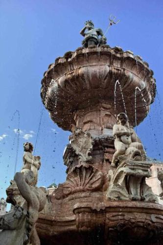 a fountain with animals and people on top of it at La Casa di Vale Muse in Trento