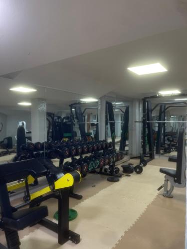 a gym filled with lots of rows of dumbbells at Résidence De Luxe AL Manzah in Al Hoceïma