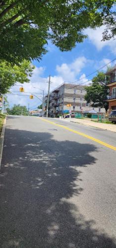 an empty street in a city with a building at Modern 2BR Apartment Jamaica Queens NYC in Hillside