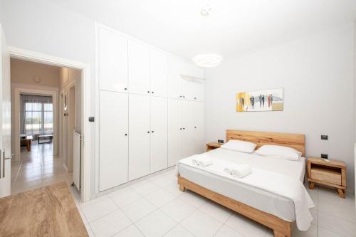 biała sypialnia z dużym łóżkiem i białymi szafkami w obiekcie Villa Katrin w mieście Kisamos
