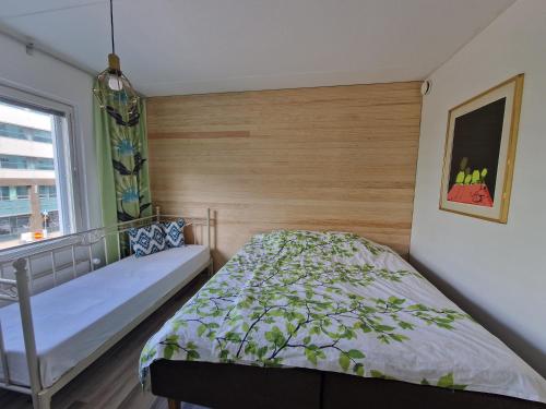 a bedroom with a bed and a window at Bright, big apartment with own sauna & balcony in Helsinki
