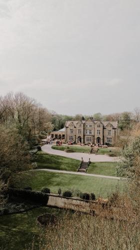 a large building with a park in front of it at Woodlands Hotel in Leeds