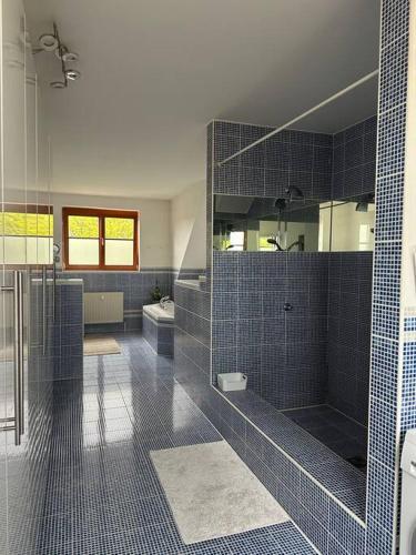 a large bathroom with a shower and a sink at Freundliche Wohnung Nähe Weinstraße für 5 Personen in Wagna