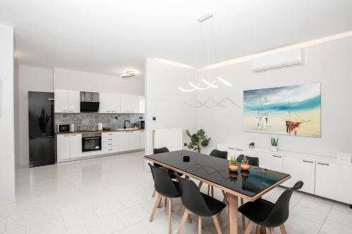 a kitchen and dining room with a table and chairs at Villa Katrin in Kissamos