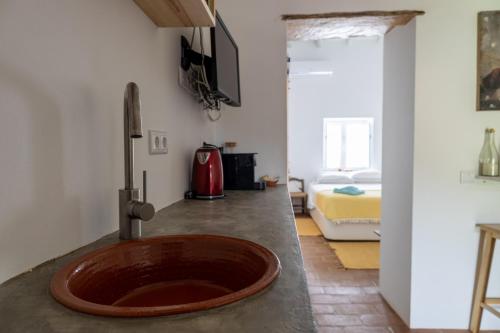 a bathroom with a wooden sink on a counter at Sunrise Monsaraz Green - 1km Castelo Monsaraz com telheiro e jardim in Monsaraz