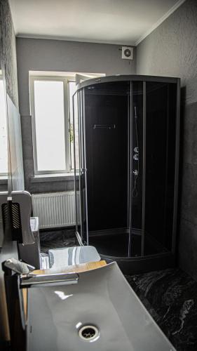 a bathroom with a shower and a sink at People Guest House in Bishkek