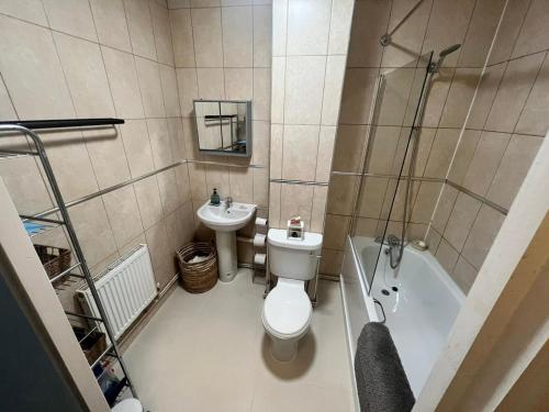 a small bathroom with a toilet and a sink at Room with share bathroom in London