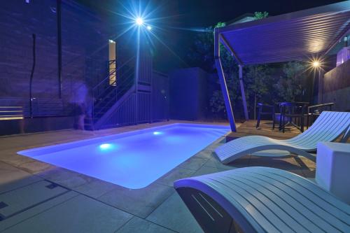 a swimming pool in a backyard at night at ルクス箱根湯本 LUX HAKONE YUMOTO in Hakone
