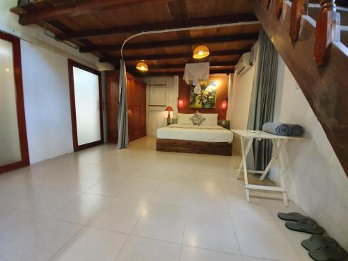 a bedroom with a bed and a table in a room at An Bang Hideaway in Hoi An