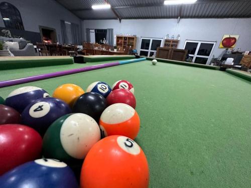 a group of billiard balls on a pool table at Cadeau Hiking and Accommodation in Witelsbos