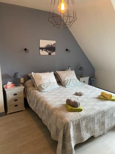 Un dormitorio con una cama con un osito de peluche encima. en Chambres du Vau-Nogues, en Pleudihen-sur-Rance
