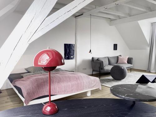 a bedroom with a bed and a red lamp at Zehuus mit Domblick und Dachterrasse in Cologne