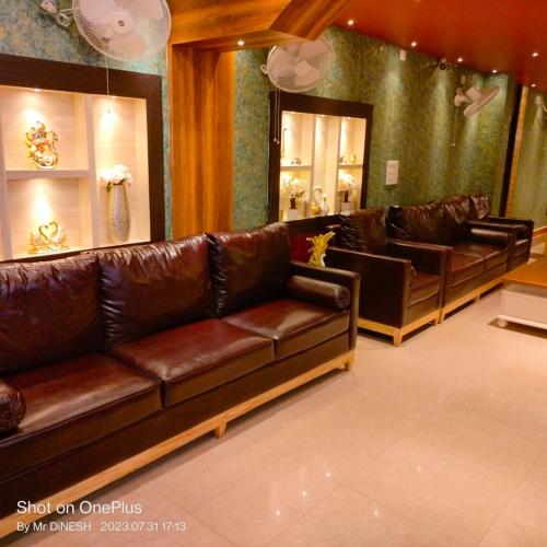 a lobby with leather couches in a store at karisma premium in Bhubaneshwar