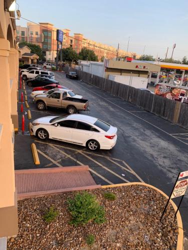 a white car parked in a parking lot at Americas Best Value Inn-Near NRG Park/Medical Center in Houston
