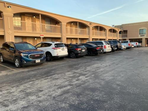 a row of cars parked in front of a building at Americas Best Value Inn-Near NRG Park/Medical Center in Houston