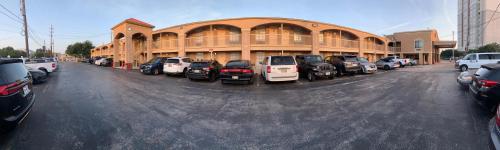 a parking lot with cars parked in front of a building at Americas Best Value Inn-Near NRG Park/Medical Center in Houston